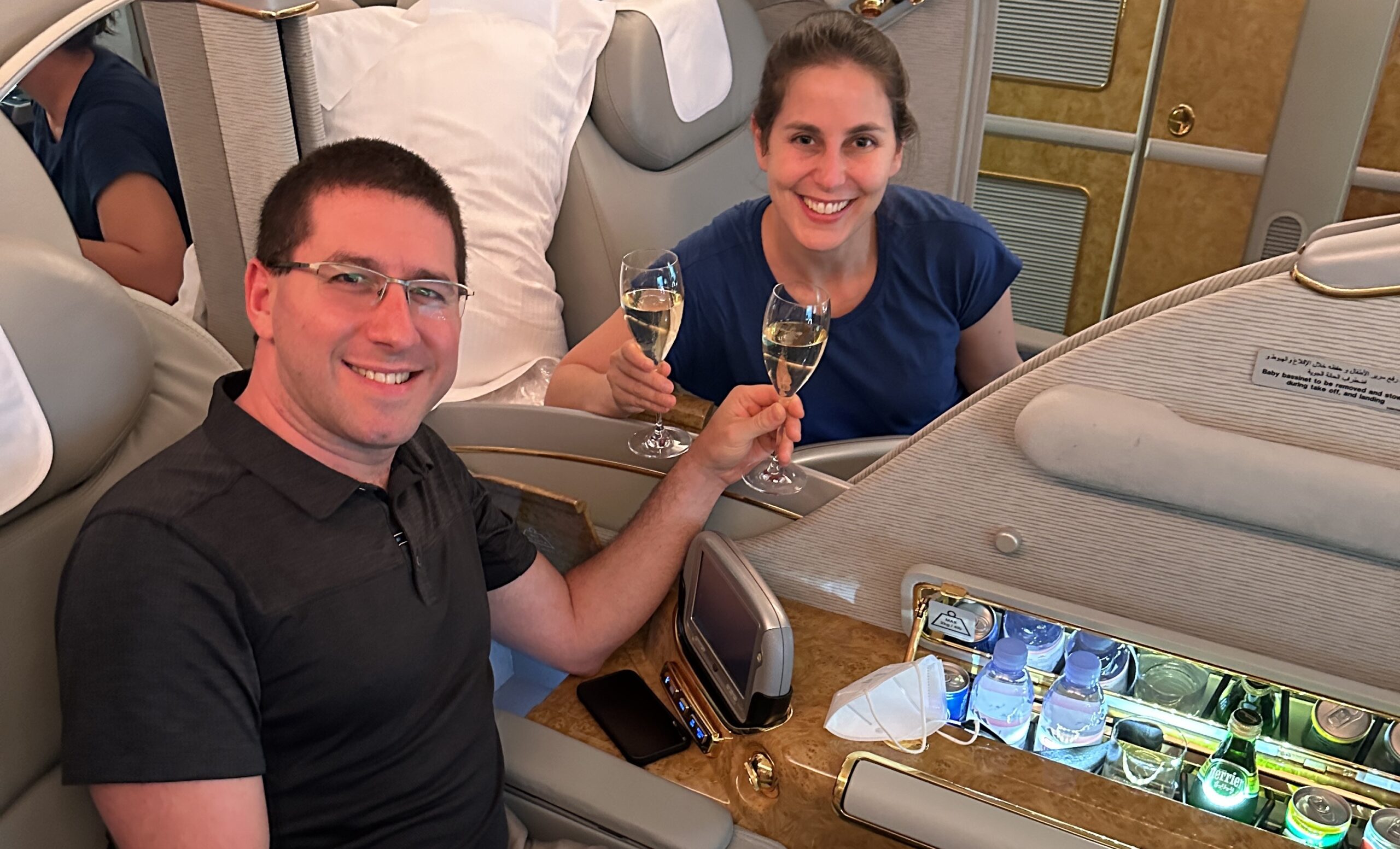 Brian and Rebecca drinking champagne on Emirates First class